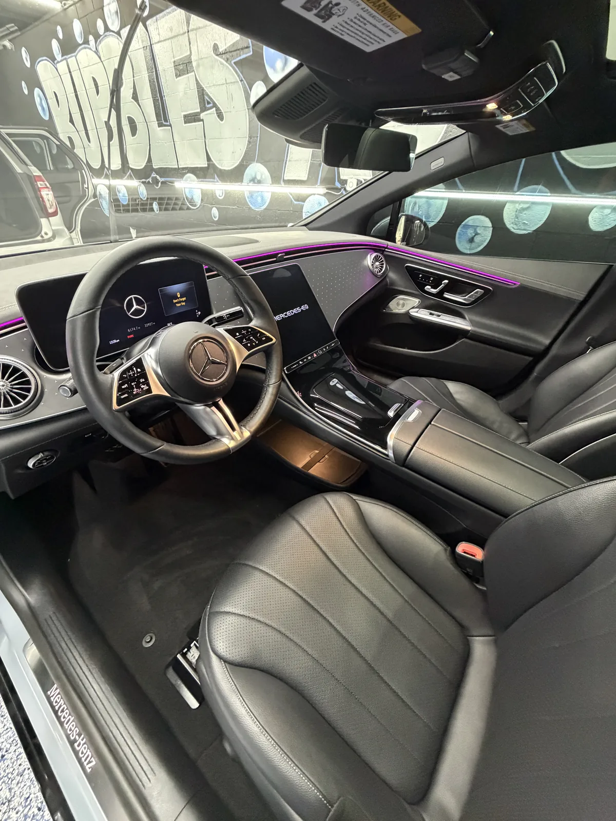 Mercedes front cabin with black leather seats and the steering wheel